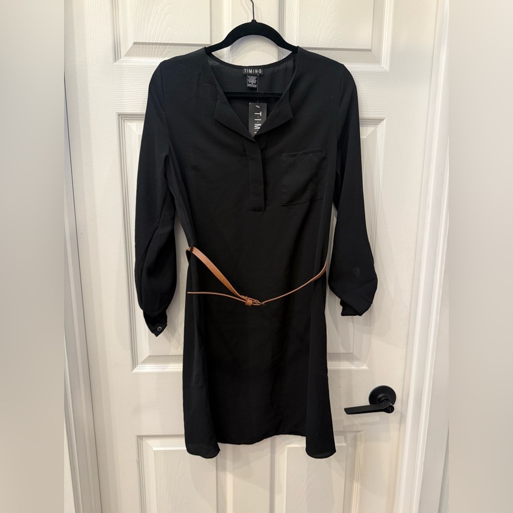 Black mini dress with mid length sleeves and brown belt